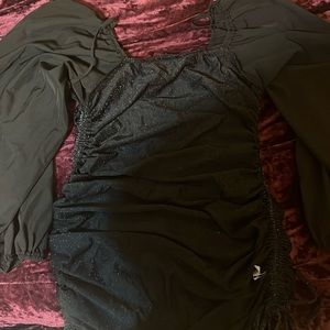 It’s a sparkling black dress with sleeves